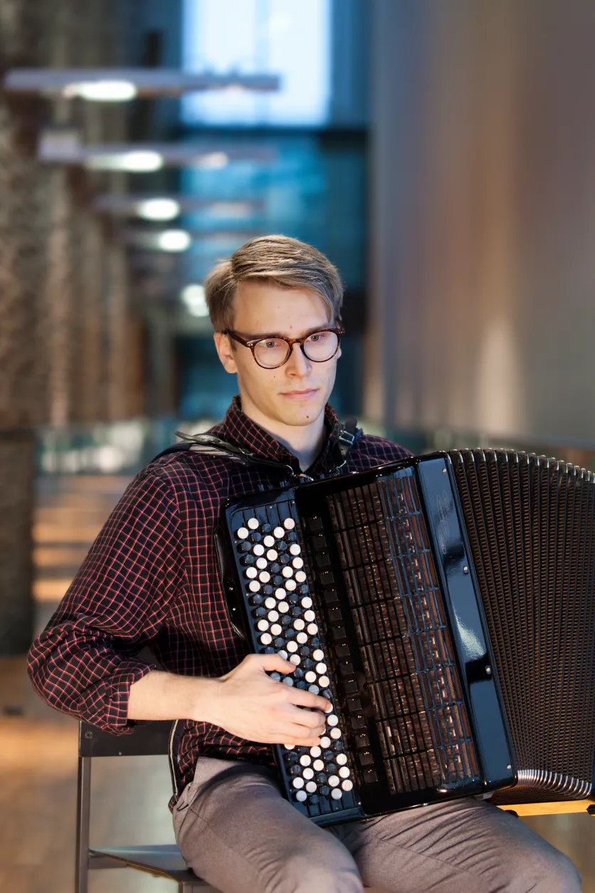Matti Pulkki seated with accordion